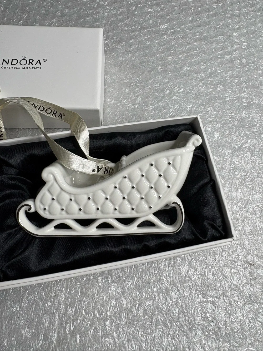 Pandora white porcelain sleigh ornament